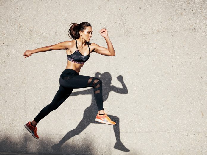 Fit young woman jumping and running