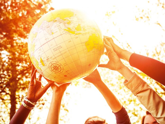 Group of teenagers holding an earth globe