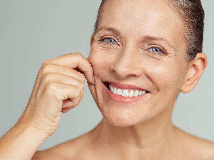 Beauty mature woman pulling perfect skin