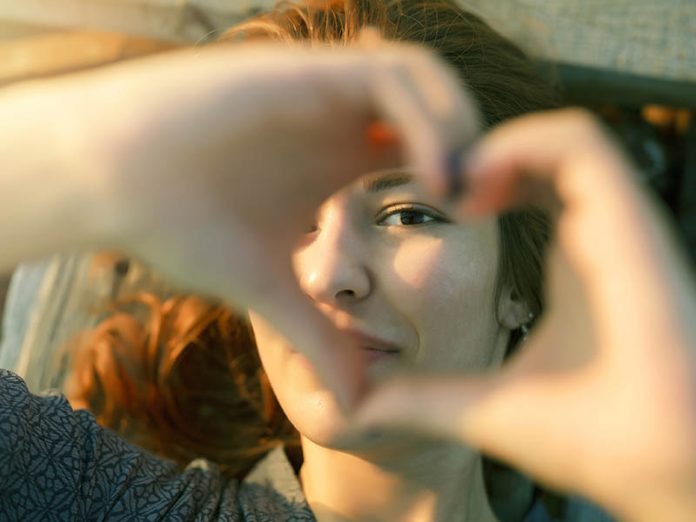 Woman making heart shape with hands