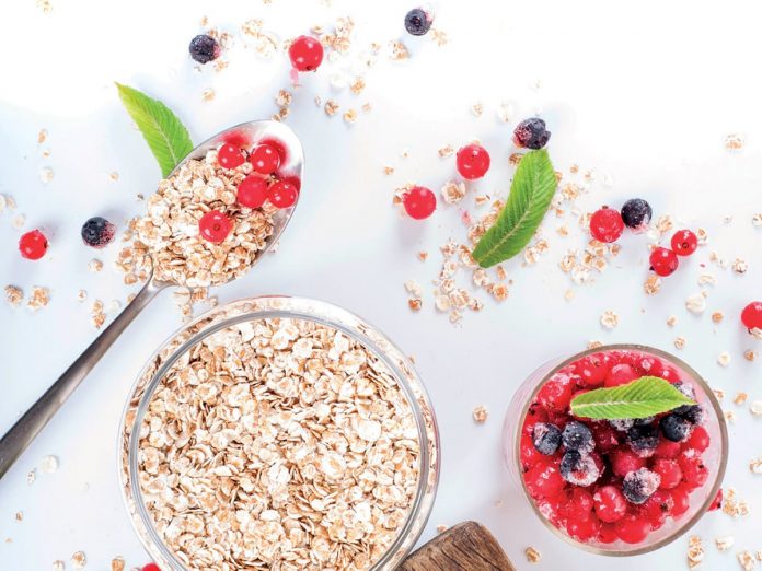 healthy breakfast: oat flakes in bowls, fresh berries and milk o