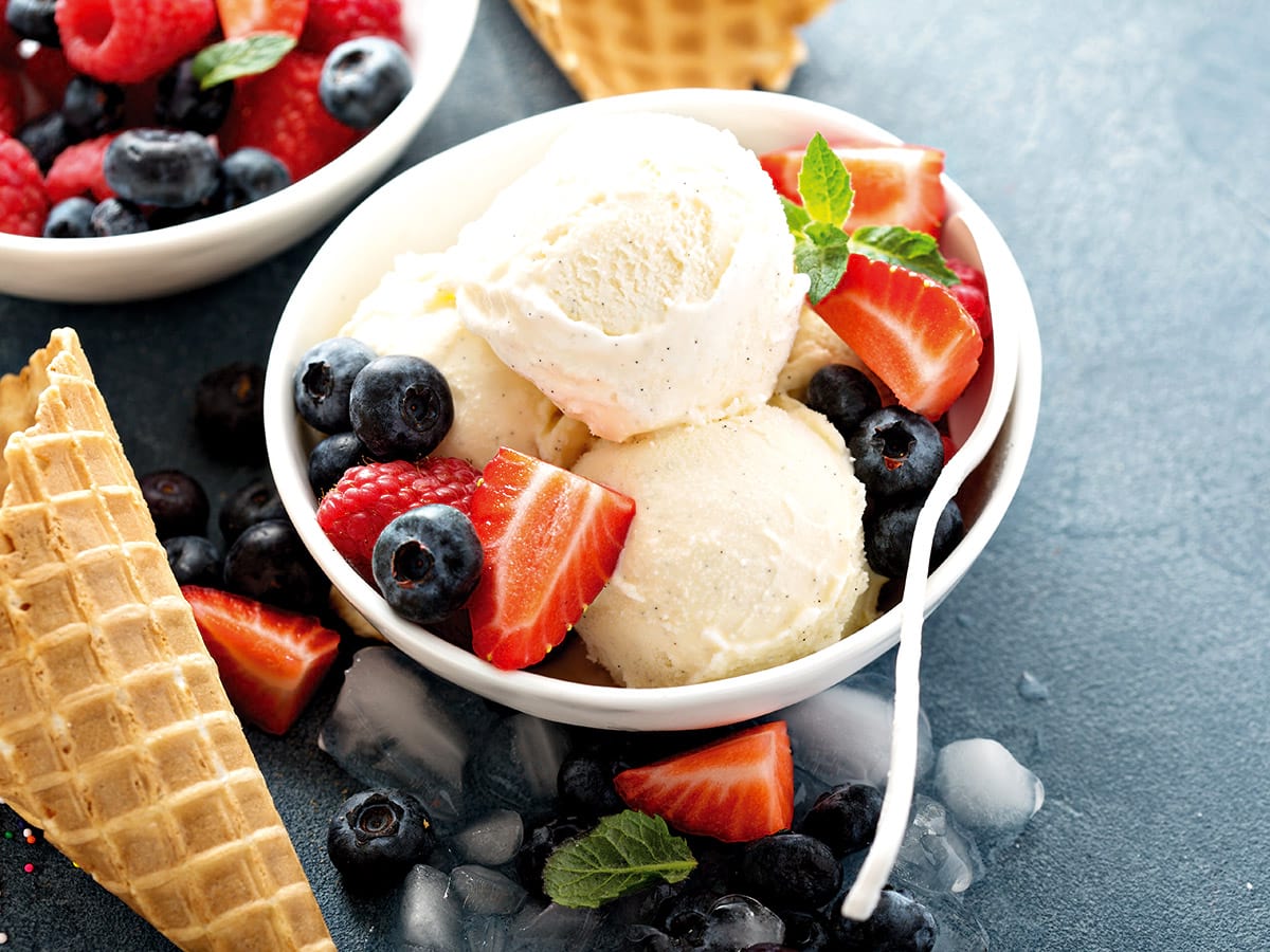 Vanilla ice cream scoops with berries